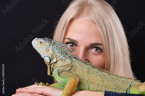 Beautiful girl portrait and green iguana