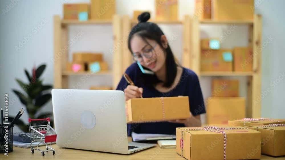 Woman Working at home with Online Business.Asian woman is working with financial documents at workplace in the office. Woman Working at home with Online Business.Asian woman is working with financial documents at workplace in the office.