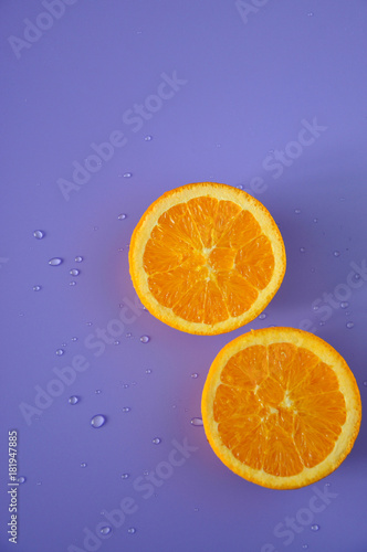 Half of Fresh Orange on Purple Background