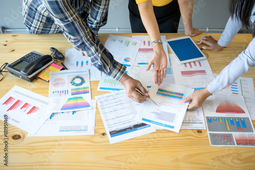 Business consultant is checking and analysis sales figures to plan business strategies with the team.