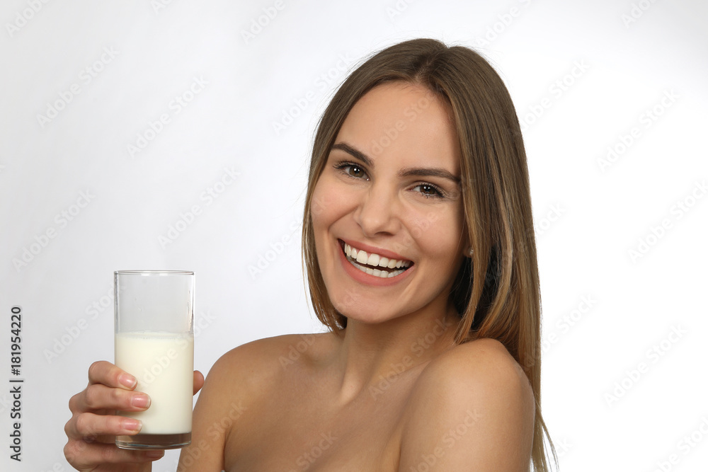 Hübsche blonde Frau mit nackten Schultern und einem Glas Milch lacht Hübsche blonde Frau mit nackten Schultern und einem Glas Milch lacht