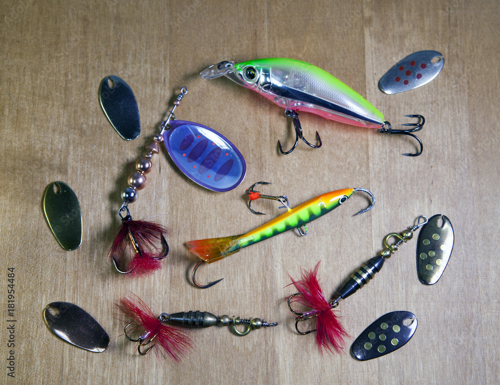 Fishing tackle, Different spinners for a bait of fish on wooden  background.. Stock Photo