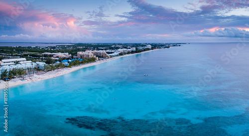 aerial panoramic view of seven mile beach in the tropical paradise of the cayman islands in the caribbean sea after sunset