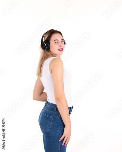 Young cute girl listens music, isolated 