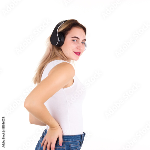 Young cute girl listens music, isolated 