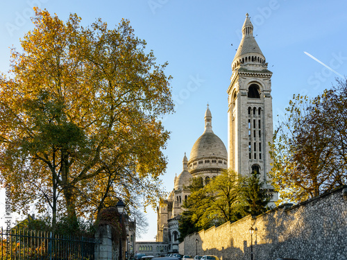Back view of the Basilica of the Sacred Heart of Paris at sunrise in autumn with the square steeple in the foreground.