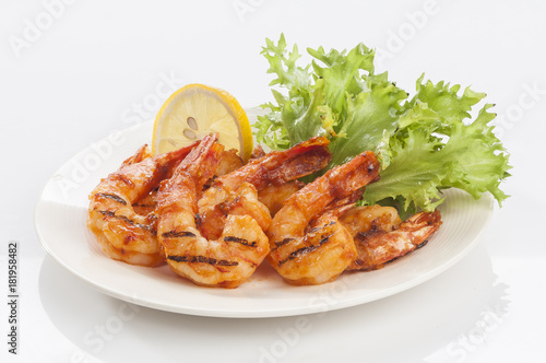 Grilled Jumbo headless shrimp with tikka marinade with lemon tomato and lettuce 