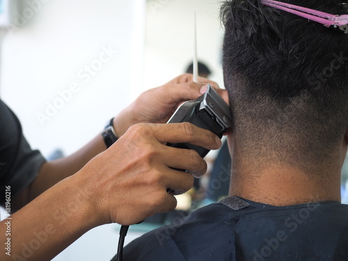 man getting haircut at barber shop