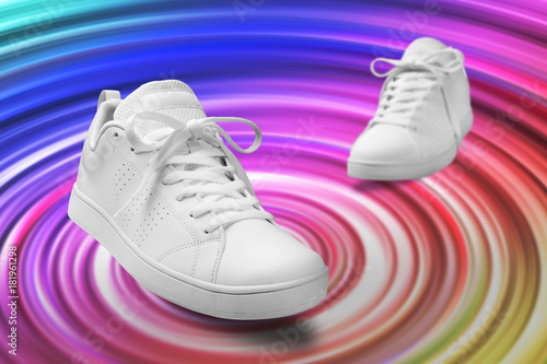 Pair of White sneaker composition like dancing on color full spin cicle background with clipping path