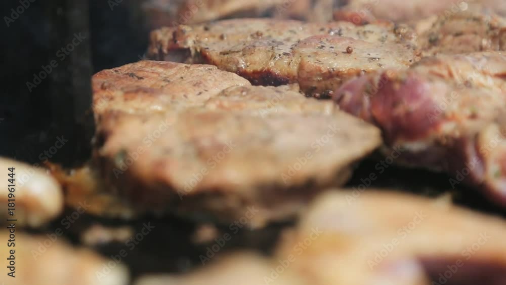 Pieces of grilled meat on the grill