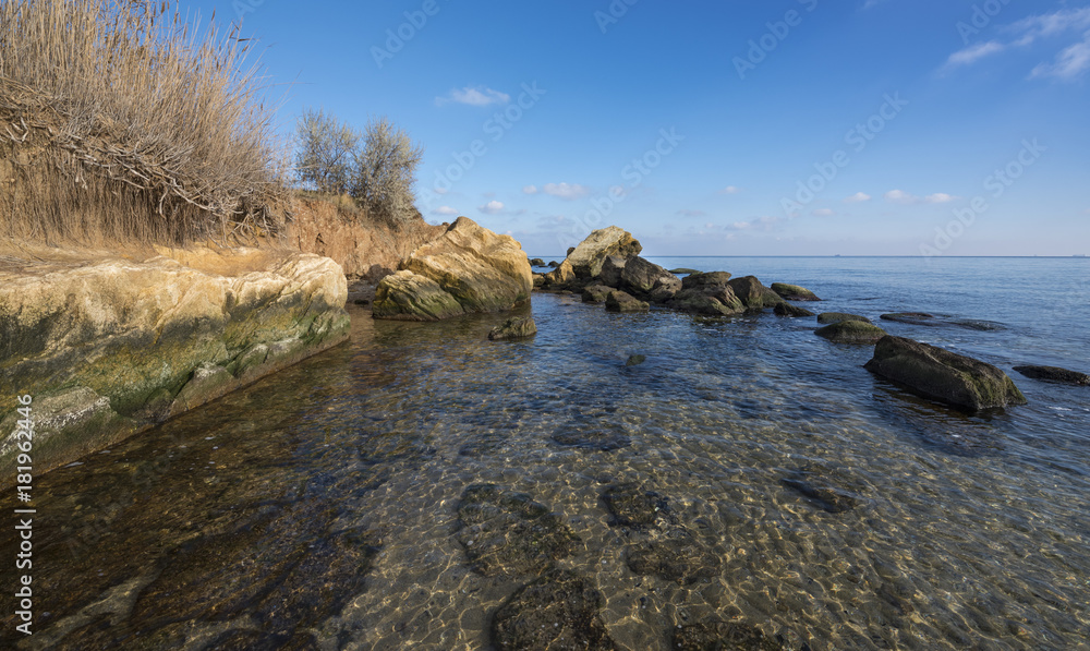 Beautiful seaside  and many stones in trasparent water in sunny day