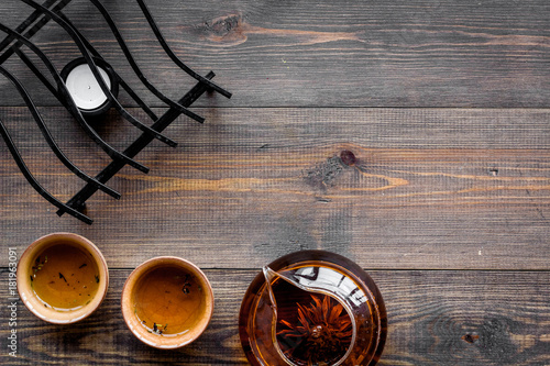 Tea break. Cookware fo tea ceremony. Tea pot and cups on dark wooden background top view copyspace