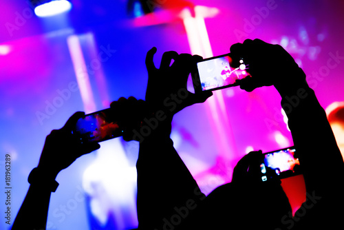 Blurred. Video recording of the concert on the smartphone phone of the Beach or club party. Conceptual background of the youth party. 