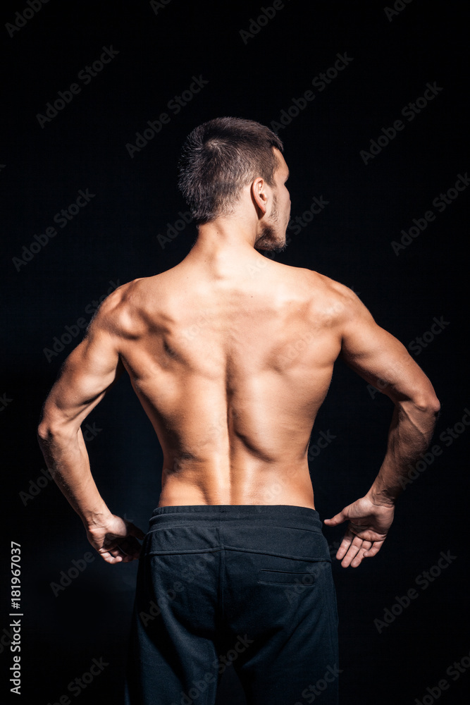 young handsome man with perfect torso on black background; young handsome man with perfect torso on black background;
