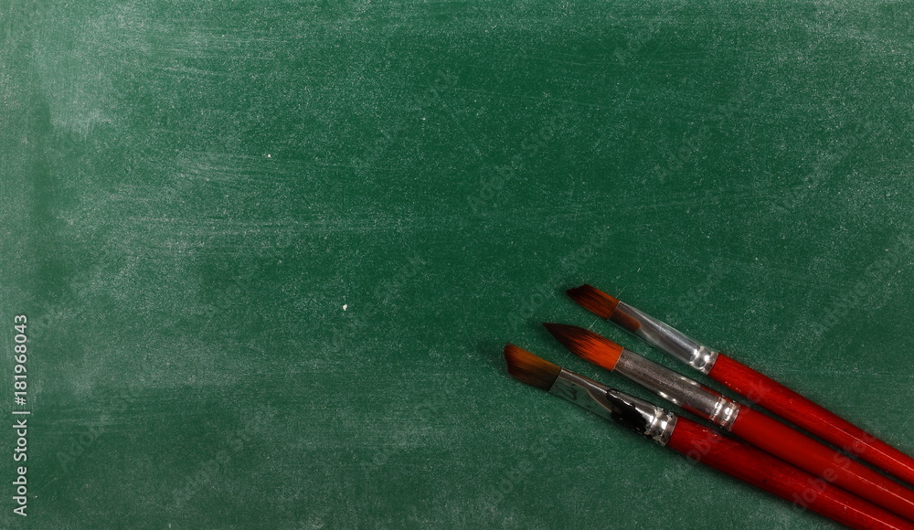 Paintbrushes on chalkboard, blackboard and texture Paintbrushes on chalkboard, blackboard and texture