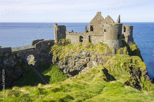 Dunluce Castle (Irish: Dún Libhse), a now-ruined medieval castle located on the edge of a basalt outcropping in County Antrim, Northern Ireland photo
