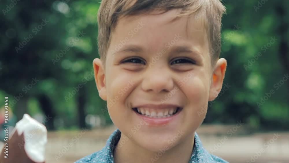Boy eating ice cream and smiling to the camera Boy eating ice cream and smiling to the camera