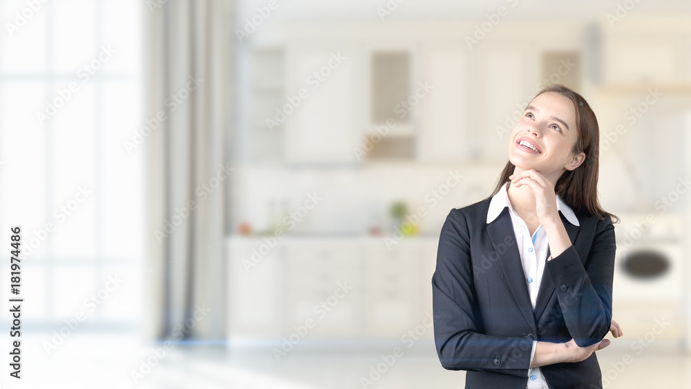 Young beautiful business woman and creative designer standing over blured interior background Young beautiful business woman and creative designer standing over blured interior background