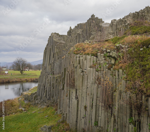 basalt column pillars lava vulcanic rock formation organ shape with lake panska skala in kamenicky senov prachen czech republic photo