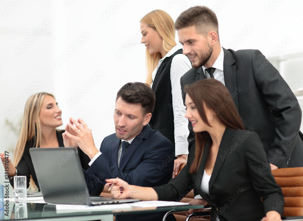 business team discussing new information , standing in front of the open laptop business team discussing new information , standing in front of the open laptop