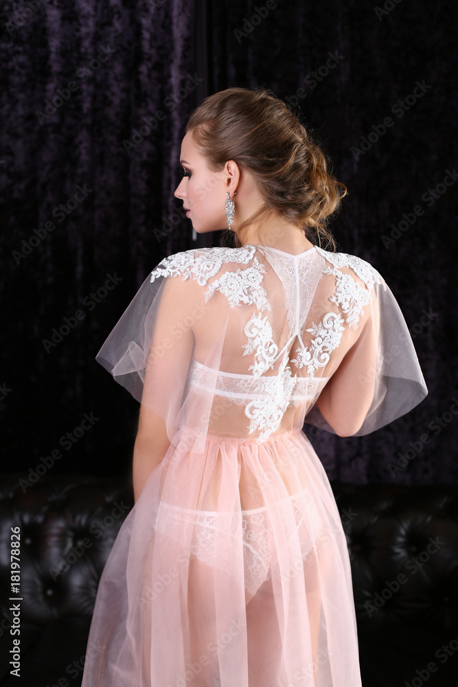 Fototapeta premium bride in a beautiful peignoir in interior