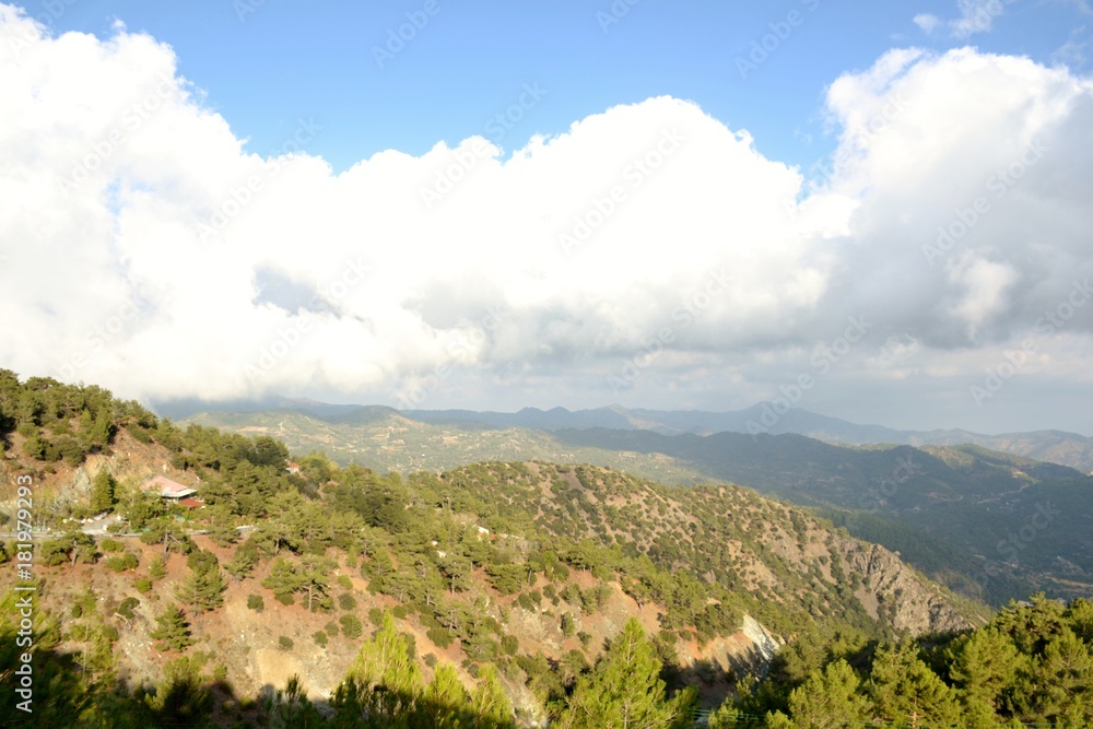 Landscape of Troodos mountains from Cyprus and cloudy blue sky