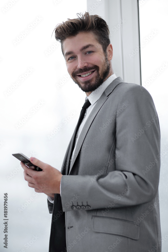 Stylish man in suit is reading information on phone Stylish man in suit is reading information on phone
