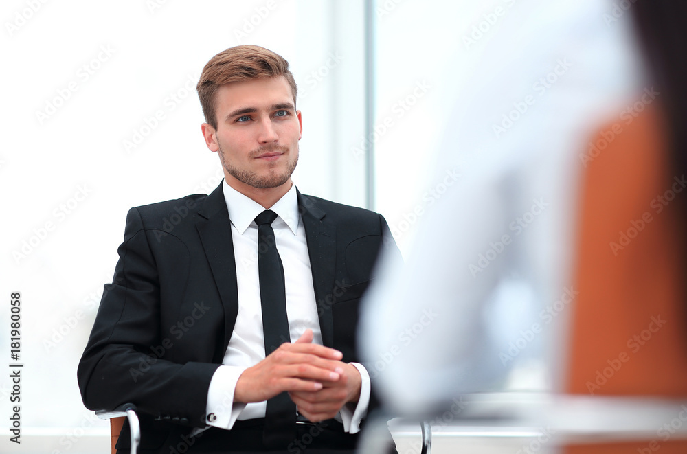 closeup . serious businessman sitting in an office chair. closeup . serious businessman sitting in an office chair.