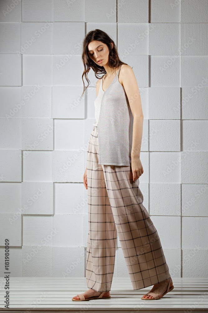 Attractive girl in sleeveless knitted blouse and wide pants Attractive girl in sleeveless knitted blouse and wide pants