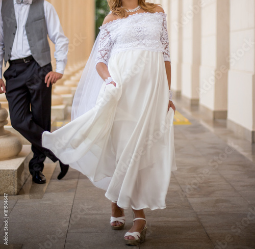 Happy bride and groom at wedding walk in park