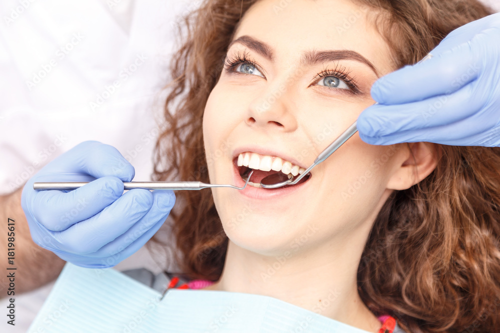 Dentist examining a patient's teeth in the dentist