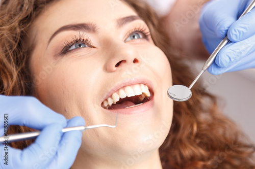 Dentist examining a patient's teeth in the dentist