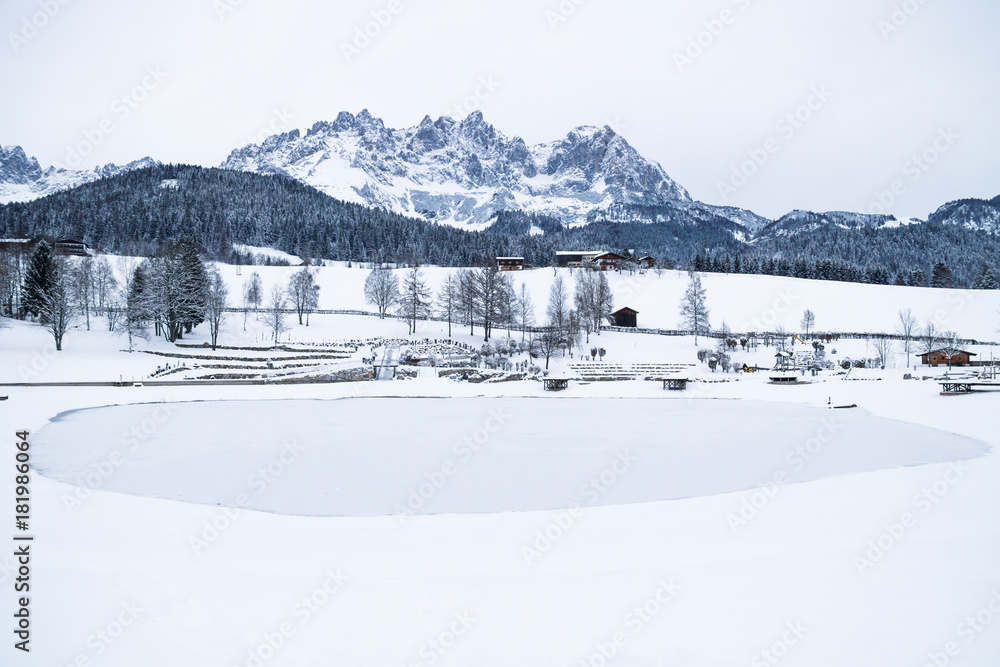 Wilder Kaiser mountainrange with snow with frozen lake, Going am Wilden Kaiser, Tyrol, Austria