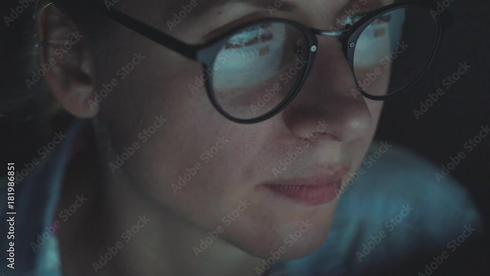 Woman in glasses looking on the monitor and surfing Internet Woman in glasses looking on the monitor and surfing Internet