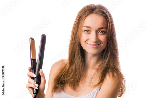 Beautiful young woman hair ironing