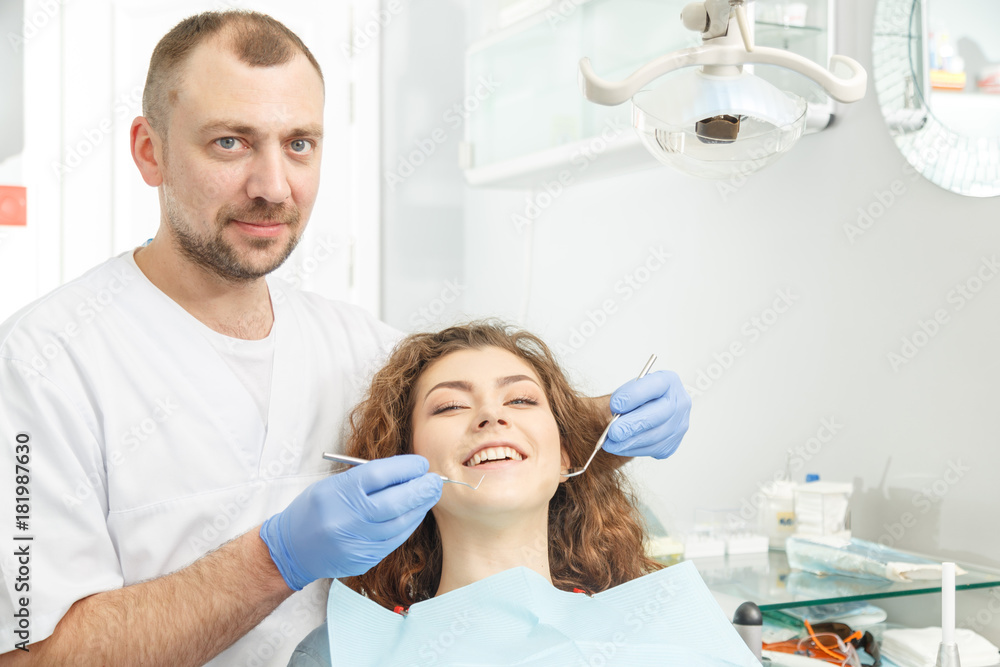 Fototapeta premium Dentist examining a patient teeth in the dentist clinic