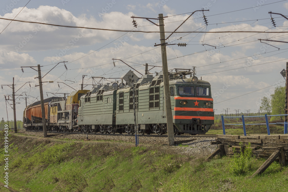 Naklejka premium Green freight train transports cargo by rail