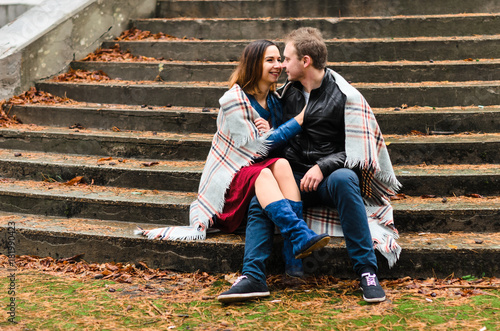 The guy with the girl walking in the Park , near the old building.