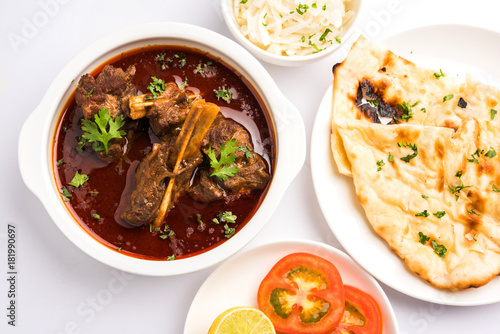 Mutton Masala Or Masala Gosht or indian lamb rogan josh with some seasoning, served with Naan or Roti, selective focus
