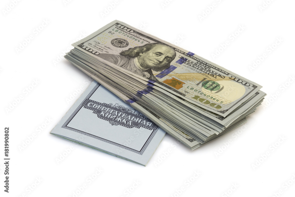 One hundred dollars banknotes lie on checkbook isolated on white background One hundred dollars banknotes lie on checkbook isolated on white background