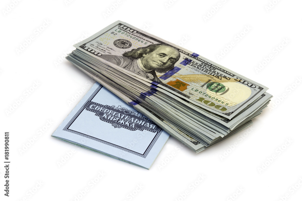 One hundred dollars banknotes lie on checkbook isolated on white background One hundred dollars banknotes lie on checkbook isolated on white background