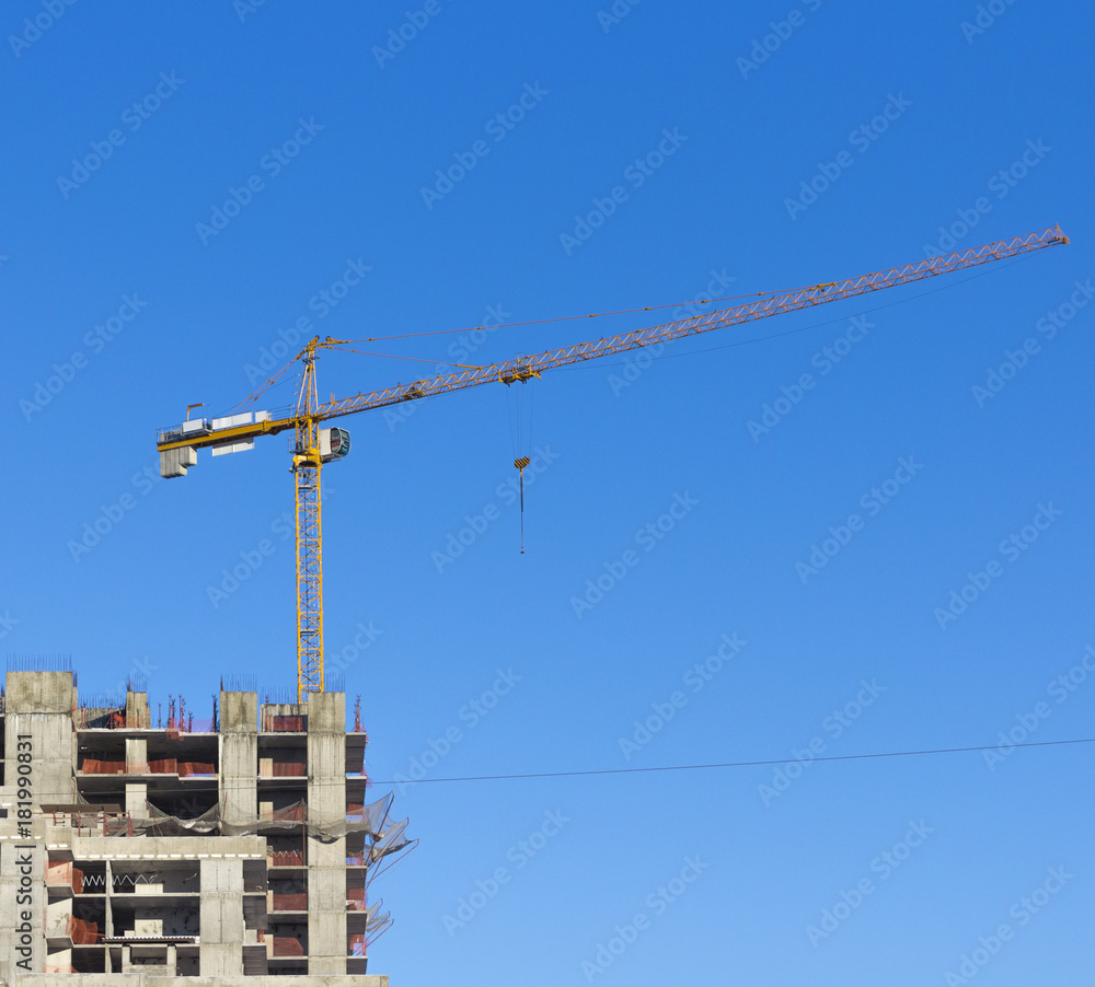 Construction site with two cranes against the sky Construction site with two cranes against the sky