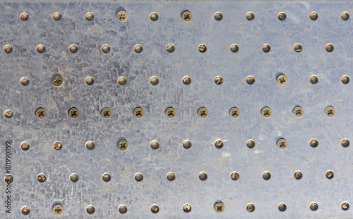 Texture of the metal plate with bolts and holes