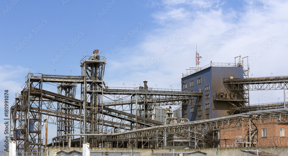 Pipes oil refining factory against a blue sky Pipes oil refining factory against a blue sky