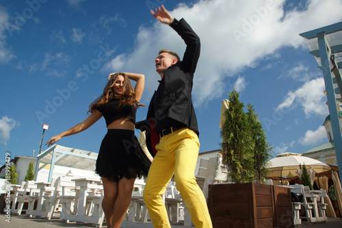Couple of dancers dancing bachata on a city street