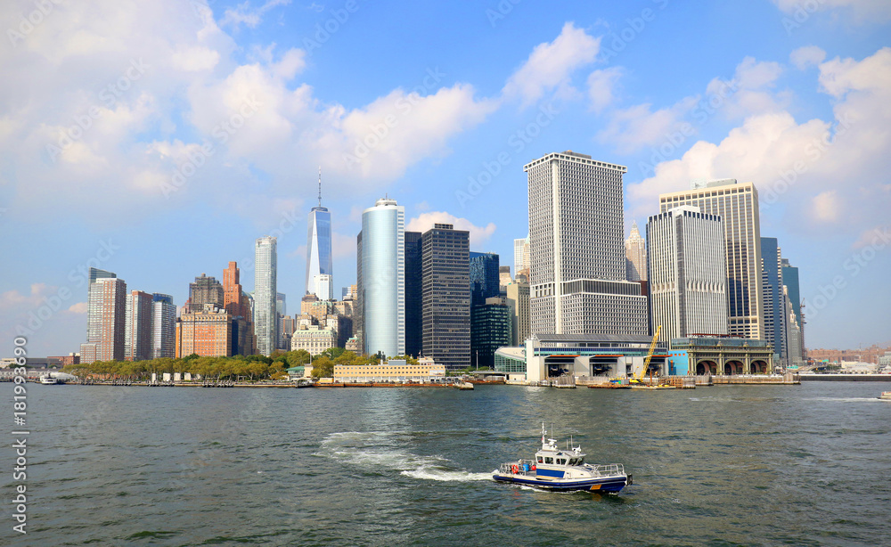 Lower Manhattan skyline on a Clear Blue day, Police Boat in foreground. New York City