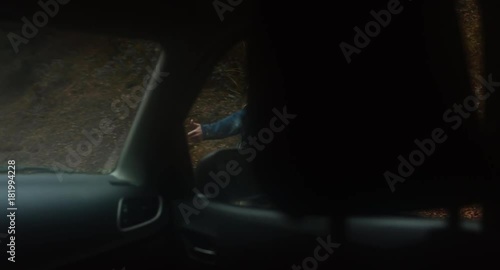 POV Car driver stops to pick hitchhiking girl on a forest road in mountains. 4K UHD 60 FPS SLO MO