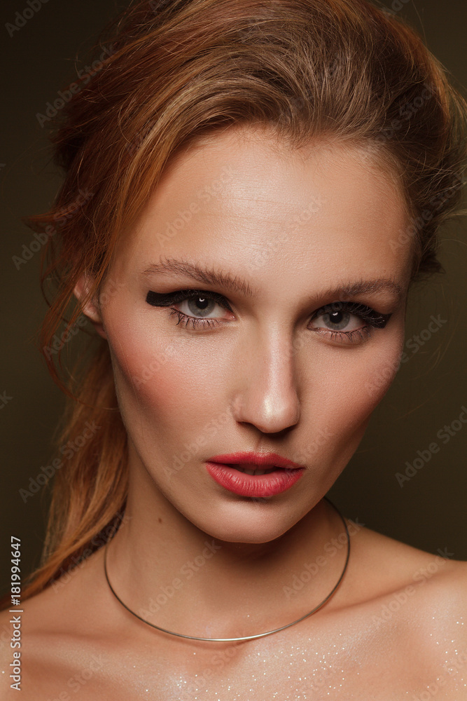 Fashionable portrait of a beautiful girl in the studio with jewelry and makeup Fashionable portrait of a beautiful girl in the studio with jewelry and makeup
