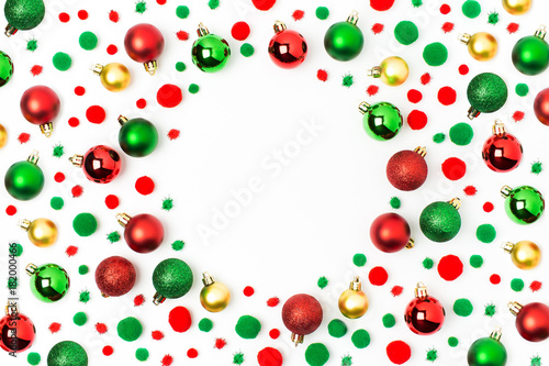 Fototapeta Naklejka Na Ścianę i Meble -  Frame  made of red and green Christmas balls on white background. Flat lay, top view