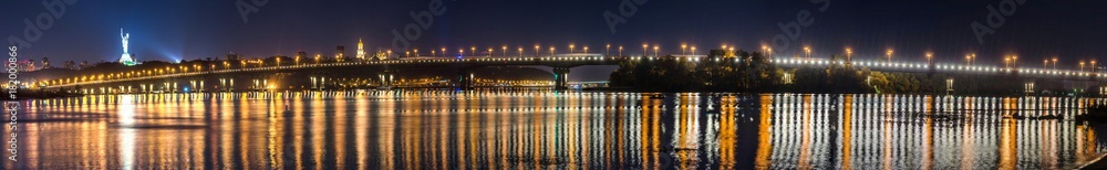 Night panorama of the Paton bridge across the Dnipro in Kyiv